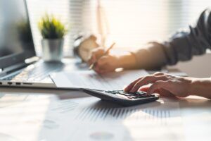 A man working on his taxes and wondering, “Are wrongful death settlements taxable?”