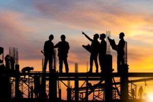 Construction workers at sunset. Discuss your legal situation with a Chapel Hill construction accident lawyer.