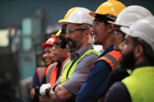 A line of construction workers. You can take steps to get compensation after an injury with a Rocky Mount construction accident lawyer.Â