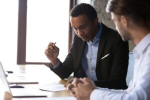 A lawyer meets with his client and explains how much car insurance goes up after an accident.
