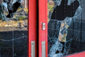 A broken business door. Discuss your legal situation with a Raleigh commercial property damage lawyer.