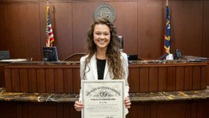attorney Telana Poe holding North Carolina State Bar admission certificate