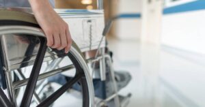 man in wheelchair after paralysis