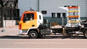 New Empty Orange and Yellow Tow Truck Parked on the Road