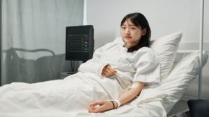 Young Asian Patient In Hospital Bed