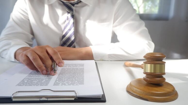 Lawyer Presents a Contract with Gavel and Legal Law