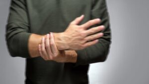 A Man with a Tremor Tries to Keep His Hand from Trembling