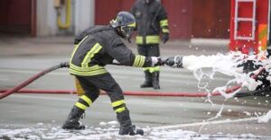 A firefighter uses AFFF to extinguish a fire. The firefighter was diagnosed with cancer and is considering hiring a Raleigh firefighting foam lawsuit lawyer to explore his options for compensation.