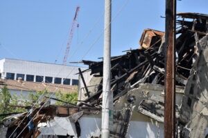 A commercial property lies in shambles after an accident while a Kinston attorney and client assess the damage.