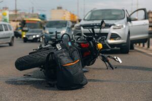 A motorcycle lies on the road after colliding with a vehicle, leaving the rider wondering how common motorcycle accidents are and what to do next.