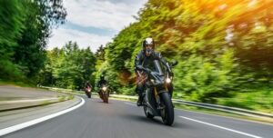 Motorcyclists drive together on a highway, leaving nearby drivers wondering, “Is lane splitting legal in North Carolina?”