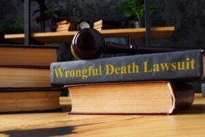 A stack of books including information about how to file a wrongful death lawsuit sits on a table.