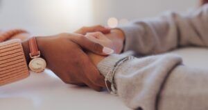 Two women comforting each other after a fatal accident. A lawyer can explain if wrongful death is a civil or criminal claim. 
