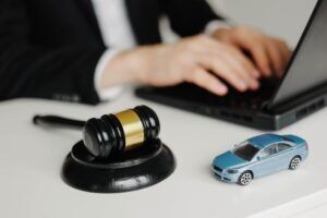 A man using a computer wonders, “How much does a car accident lawyer cost?”