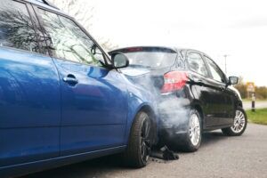 Two cars after a rear-end accident with damage to both vehicles