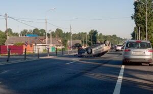 An overturned vehicle rests beside a highway after a serious North Carolina traffic accident.